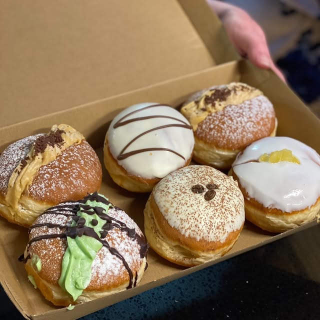 A box of six iced and filled doughnuts from Numero Uno Pizza and Pasta.
